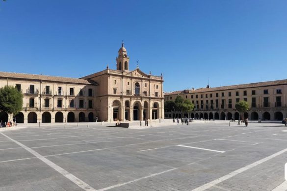 un gran edifici amb una torre del rellotge al mig de la seva zona del pati amb unes quantes persones passejant, Carpoforo Tencalla, mapes de to, una pintura mat, romànic